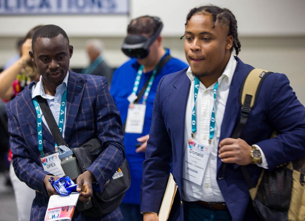 attendees walk the exhibit floor at PWX 2023 in San Diego
