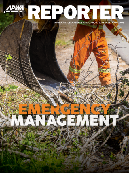 The June 2026 APWA Reporter cover, featuring a publics work professional in orange gear, and a scoop clearing debris. The text "Emergency Management" overlays the scene.