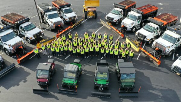 an aerial photo of public works professionals with their fleet of snow vehicles