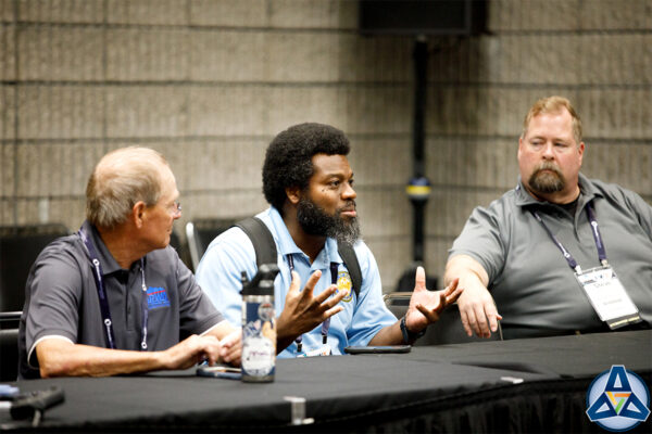 Attendee speaking about accreditation at PWX.