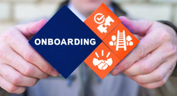 An illustration of hands holding blocks that say, "Onboarding" and related icons.