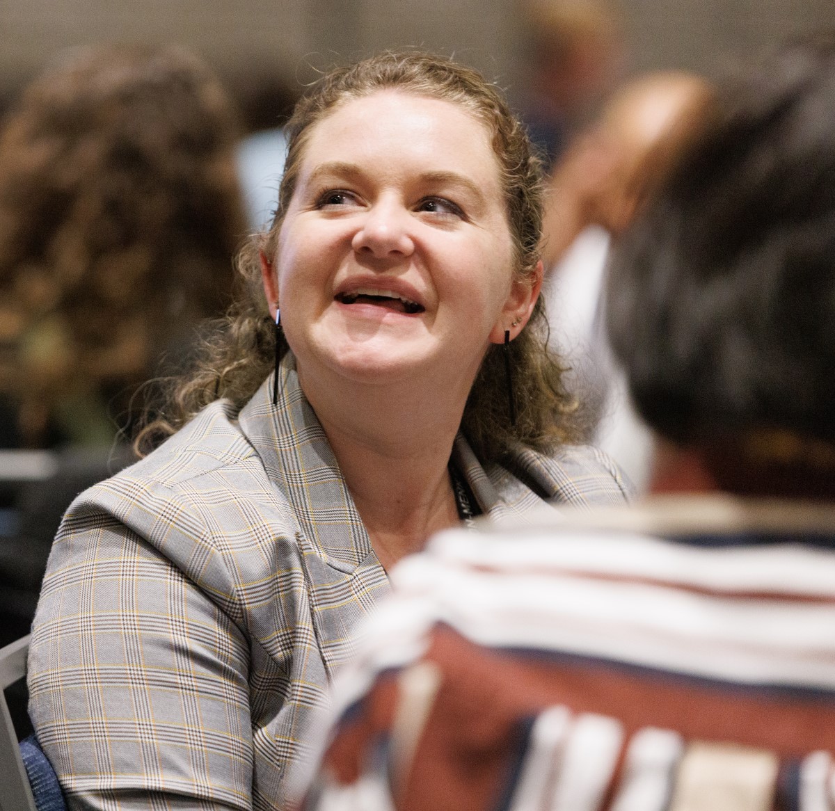 a photo of a smiling attendee at the YP Summit