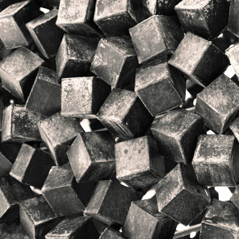 Close-up of numerous small tungsten carbide cubes.