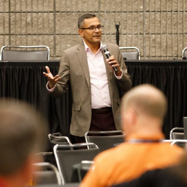 a photo of a speaker addressing the audience at PWX