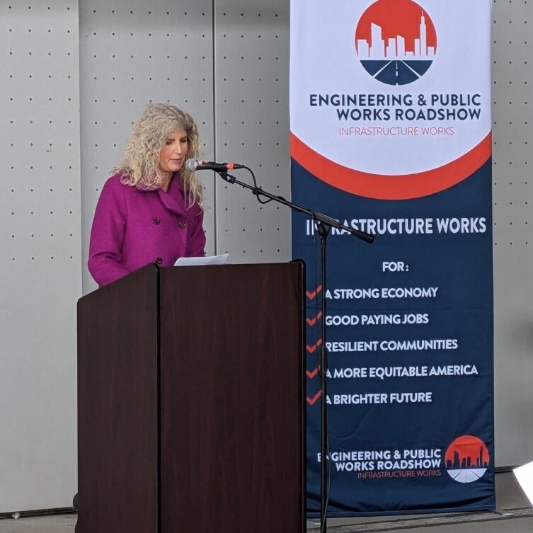 a photo of a speaker addressing the crowd at the Engineering and Public Works Roadshow event at the Colman Dock in Seattle