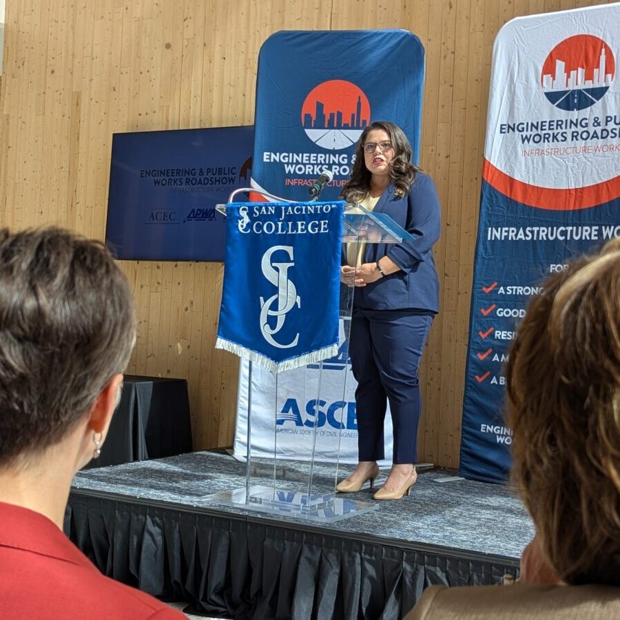 a photo of Kristina Ramirez, P.E., CPM, CFM, speaking at an Engineering and Public Works Roadshow stopped at San Jacinto College