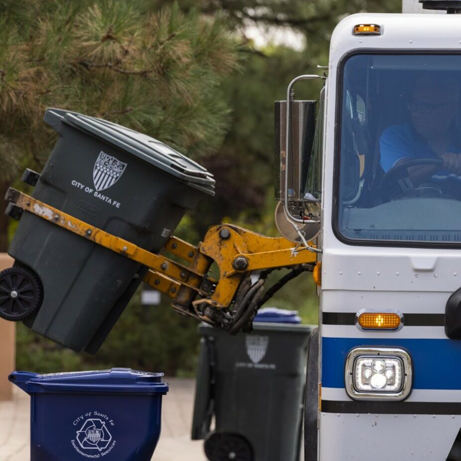 a photo of an automated side loader picking up a cart